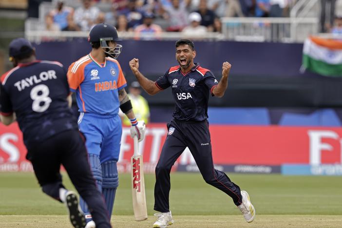 Saurabh Netravalkar, right, has become the breakout star of the U.S. national cricket team due to heroics like his dismissal of Indian superstar cricketer Virat Kohli, center, during Wednesday's match between the U.S. and India at the Nassau County International Cricket Stadium in New York. 