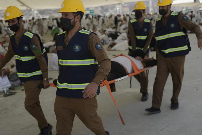 Paramedics carry a Muslim pilgrim for a medical check after he fell down due to a heat stroke near the holy city of Mecca, Saudi Arabia, on Sunday, June 16, 2024. Masses of pilgrims on Sunday embarked on a symbolic stoning of the devil in Saudi Arabia, which marks the final days of the Hajj, or Islamic pilgrimage, and the start of the Eid al-Adha celebrations for Muslims around the world.