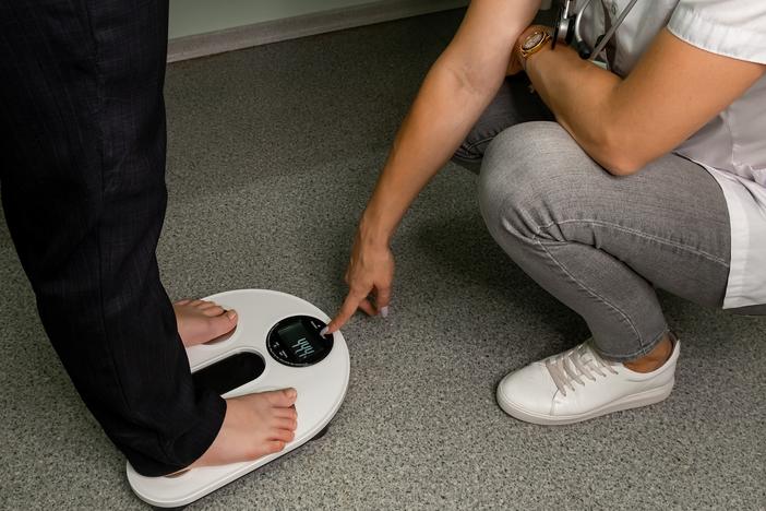 A teen gets their body composition analyzed. Behavioral counseling is recommended for kids and teens with obesity.