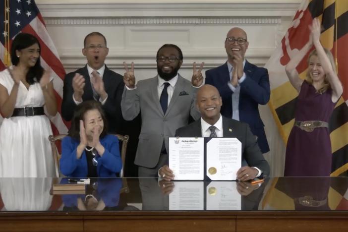  Gov. Wes Moore, center, holds an executive order authorizing pardons for at least 175,000 criminal convictions related to marijuana. Legalization, Moore said, “doesn't erase the fact that Black Marylanders were three times more likely to be arrested for cannabis than white Marylanders before legalization."