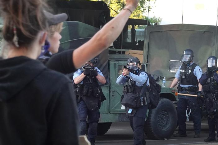 Police prepare to open fire with tear gas and nonlethal rounds on a group of demonstrators protesting the death of George Floyd on May 29, 2020, in Minneapolis, Minn.  