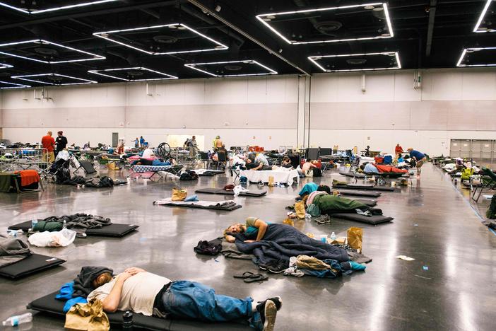 People rested at the Oregon Convention Center cooling station in Portland, Oregon during a record-breaking heat wave in 2021. FEMA has never responded to an extreme heat emergency, but some hope that will change. (Photo by Kathryn Elsesser / AFP via Getty Images) 