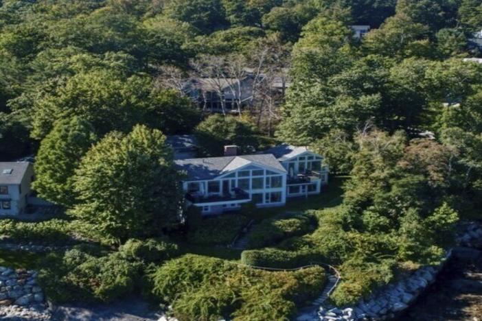 This image provided by Vinal Applebee shows the home of Lisa Gorman in the foreground, the poisoned oak trees behind her home, and the home of the alleged perpetrators behind the dead trees, in Camden, Maine.