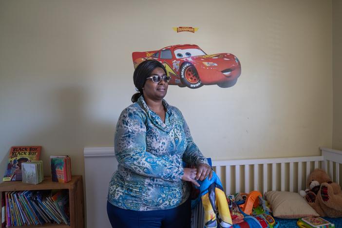 Lakethia Clark stands in her son's bedroom in her home in Tuscaloosa, Alabama. Clark will soon open her own home-based child care business.
