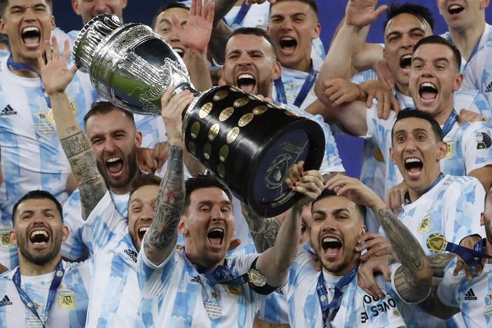 Argentina's Lionel Messi celebrates with the trophy after beating Brazil 1-0 in the Copa America final soccer match at Maracana stadium in Rio de Janeiro, Brazil, Saturday, July 10, 2021. Messi and Argentina will try to win their third straight major title when they defend their Copa America championship while Brazil hopes 17-year-old Endrick will combine with Vinícius Júnior and Rodrygo for success. (AP Photo/Bruna Prado, File)