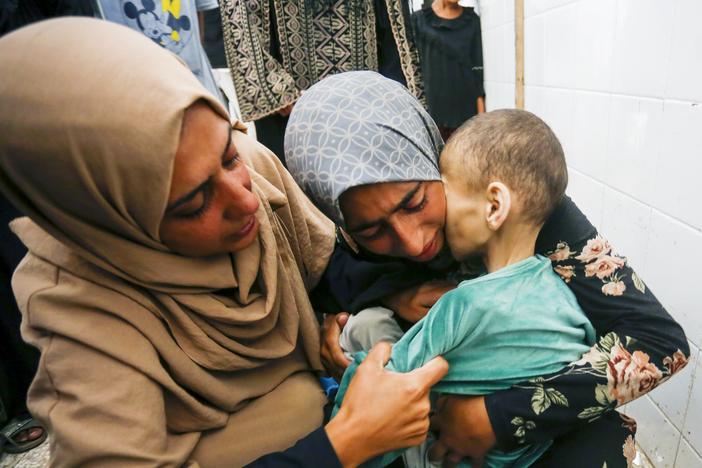 Fatma Hijazi holds the lifeless body of her 10-year-old child, Mustafa Hijazi, who died due to malnutrition and lack of medication in Deir al-Balah, Gaza. The photo is from June 14.