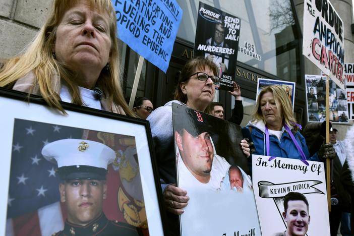 Kathleen Scarpone, left, of Kingston, N.H., and Cheryl Juaire, second from left, of Marlborough, Mass., attend a 2019 protest in front of the Arthur M. Sackler Museum, at Harvard University in Cambridge, Mass. Scarpone, who lost her son to OxyContin addiction, and Juarie addressed three Sackler family members during a virtual U.S. Bankruptcy Court hearing in March 2022.