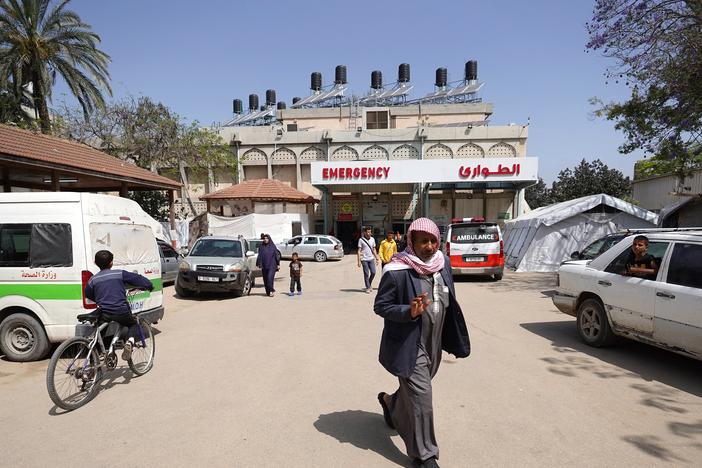 People walk outside the European hospital in Khan Younis, in the southern Gaza Strip, on May 17, amid the ongoing conflict in the Palestinian territory between Israel and the militant group Hamas. 