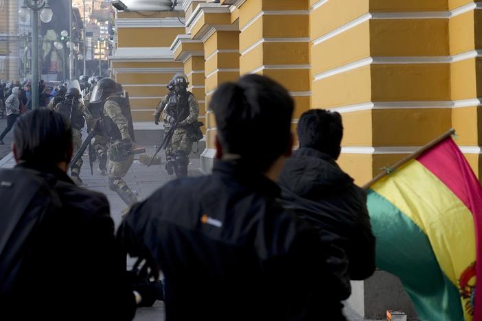 Supporters of President Luis Arce chase soldiers as they flee from Plaza Murillo, after a failed coup attempt in La Paz, Bolivia, Wednesday, June 26, 2024.