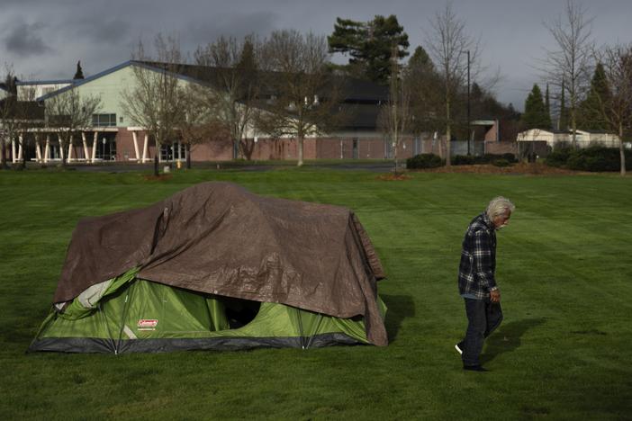 A homeless person walks near an elementary school in Grants Pass, Ore., on March 23.  The rural city became the unlikely face of the nation's homelessness crisis when it asked the U.S. Supreme Court to uphold its anti-camping laws. 