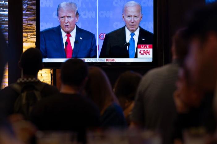 Guests at the Old Town Pour House watch a debate between President Biden and former President Donald Trump on Thursday in Chicago. The debate is the first of two scheduled between the two candidates before the November election.