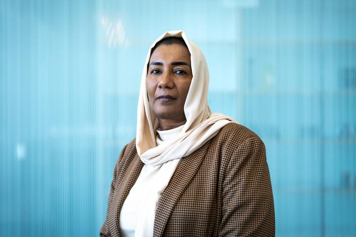 Eatizaz Yousif, the Sudan country director for the International Rescue Committee, poses for a portrait at NPR headquarters in Washington, D.C. on June 24. She herself was displaced by the conflict a year ago. “As Sudanese, we are pretty resilient," she says, referring to the fighting that has caused 12 million people to flee from their homes. "But this is beyond our resilience."