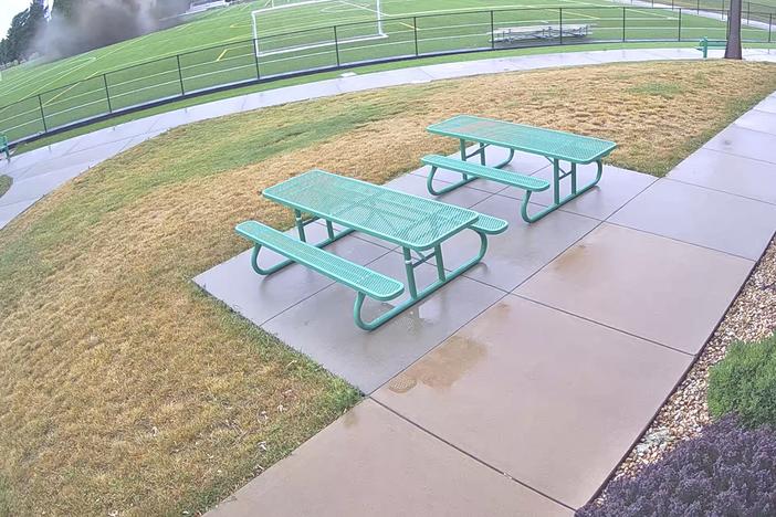 This photo provided by the City of Alton, Ill., shows security video of a sinkhole in the upper left that opened in the middle of a soccer field on Wednesday in Alton, Ill.  