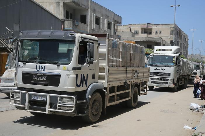 Aid trucks of the United Nations Relief and Works Agency for Palestinian Refugees in the Near East (UNRWA) deliver aid to Salah al-Din Street on the fourth day of Eid al-Adha in the east of Gaza City, Gaza on June 19, 2024.