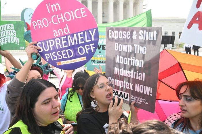 Protesters rally outside the U.S. Supreme Court on April 24 as it hears arguments on whether an Idaho abortion law conflicts with the federal Emergency Medical Treatment and Labor Act.