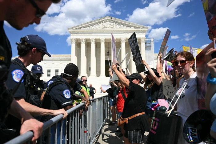 U.S. Supreme Court Police officers put up barricades to separate anti-abortion activists from abortion rights activists during a demonstration in front of the Supreme Court in Washington, DC, on June 24, 2024. 