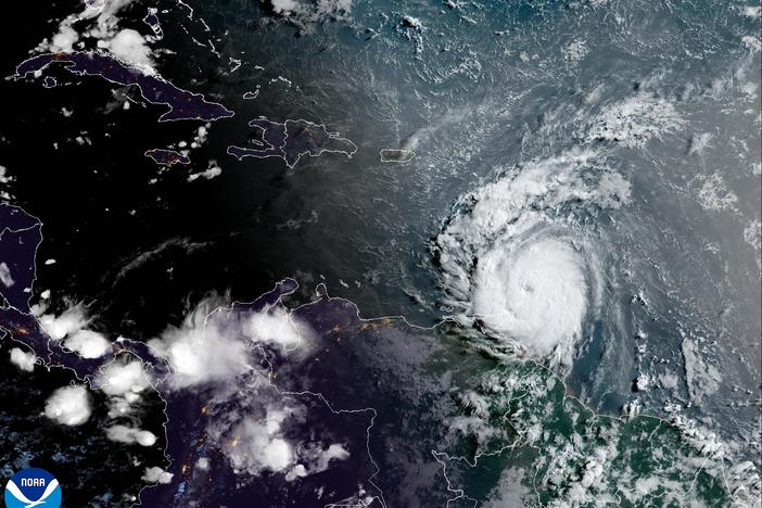 Hurricane Beryl loomed toward St. Vincent — and grew in power — as it brought threats of catastrophic winds and dangerous storm surges to the Windward Islands. The storm is seen here in a satellite image just after sunrise on Monday.