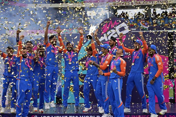 India's players celebrate with the winners' trophy after winning against South Africa in the ICC Men's T20 World Cup final cricket match at Kensington Oval in Bridgetown, Barbados, on Saturday.