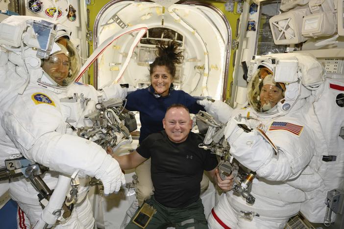 Boeing crew flight test astronauts Suni Williams and Butch Wilmore, center, pose with Expedition 71 flight engineers Mike Barratt, left, and Tracy Dyson, both NASA astronauts, in their spacesuits aboard the International Space Station's Quest airlock on June 24, 2024.