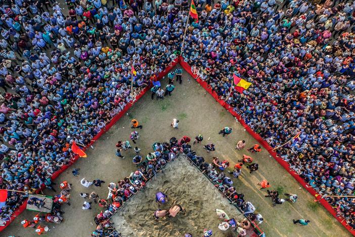 Abdul Jabbar's Boli Khela, a century-old traditional wrestling competition in Chittagong, draws thousands of eager spectators annually. In this picture captured in Chittagong, Bangladesh on April 24, 2023, two individuals are seen wrestling on a sandy stage in front of a street audience.