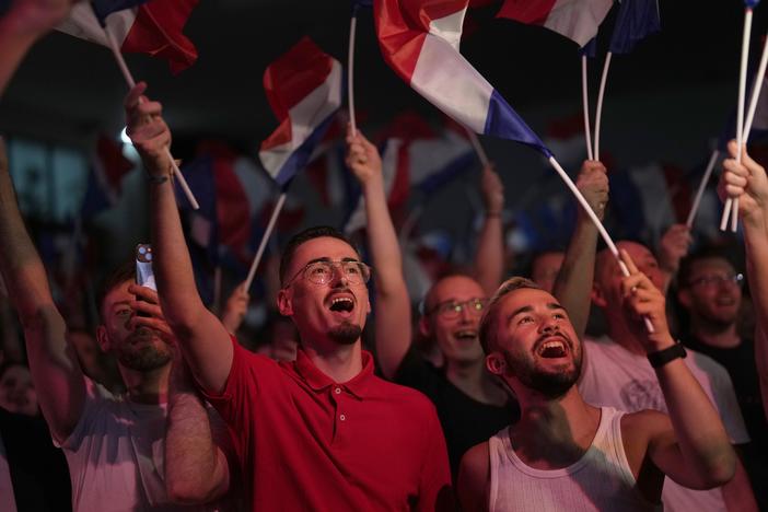 Supporters of French far-right leader Marine Le Pen react after vote projections in select constituencies, Sunday, in Henin-Beaumont, northern France. French voters propelled the far-right National Rally to a strong lead in first-round legislative elections Sunday and plunged the country into political uncertainty.