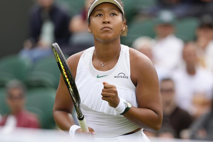 Naomi Osaka of Japan reacts after winning a point against Diane Parry of France during their first round match of the Wimbledon tennis championships in London, Monday, July 1, 2024. (AP Photo/Kirsty Wigglesworth)