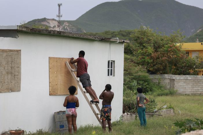 People place plywood over windows as they make last-minute preparations for the arrival of Hurricane Beryl in Kingston, Jamaica, on Wednesday.