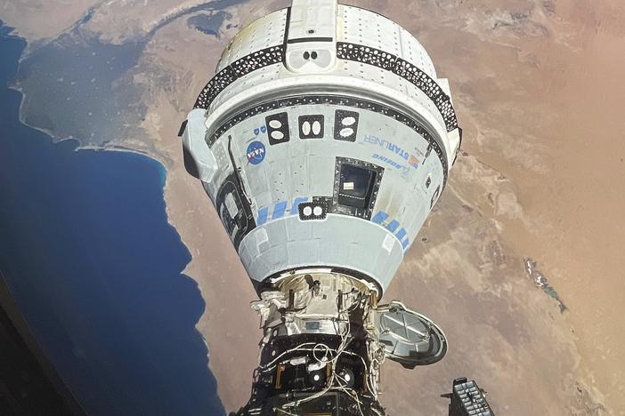 The Starliner spacecraft docked with the International Space Station and orbiting 262 miles above Egypt's Mediterranean coast on June 13. NASA says additional testing is needed before Starliner can return to Earth.