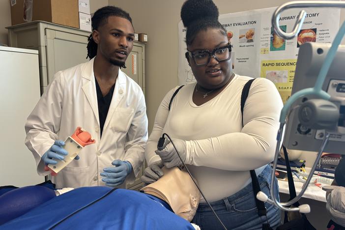 Jerrian Reedy, left, a student at the University of Mississippi School of Medicine, assists Dorothy Gray, a student at Northside High School in the Mississippi Delta, as she practices intubation in a simulation lab. Gray, who is interested in pursuing a career in the mental health care field, attended the University of Mississippi School of Medicine’s annual African American Visit Day in April. 