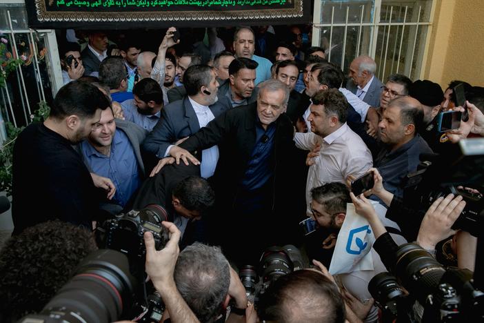 Masoud Pezeshkian, one of the two candidates qualifying for the second round of the Iranian presidential election, arrives at a polling station to cast his vote in Tehran on Friday.
