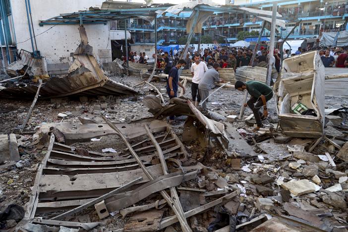Palestinians look at the aftermath of the Israeli airstrike on a U.N.-run school in the Nuseirat refugee camp in the Gaza Strip on July 6.