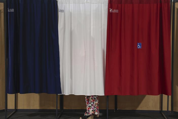 A voter stands in the polling booth during the second round of the legislative elections in Le Touquet-Paris-Plage, northern France, on Sunday. 