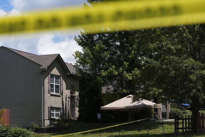 Yellow police tape is seen around the perimeter of a home where a shooting took place on Saturday in Florence, Ky. 