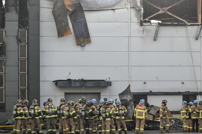 Firefighters gather at the site of a fire at a lithium battery factory owned by South Korean battery maker Aricell in Hwaseong, South Korea, on June 24.