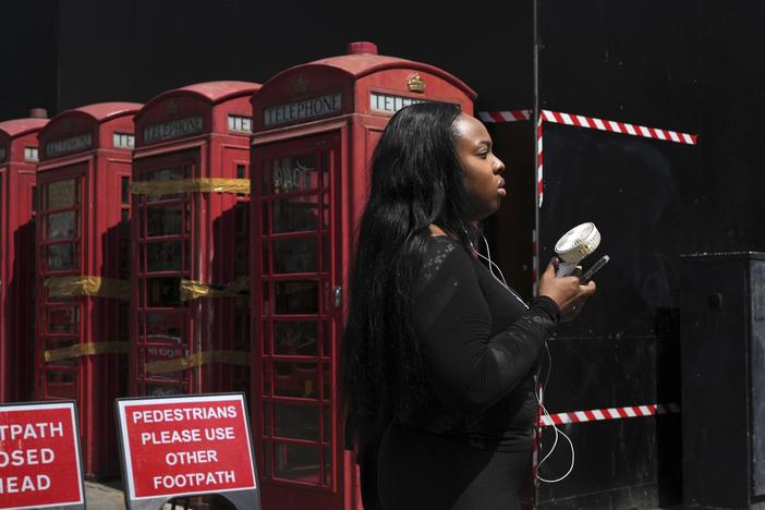 A woman cools herself with a fan during a hot day in London on June 26, 2024. June 2024 was the hottest June on record, according to Europe's Copernicus climate service.