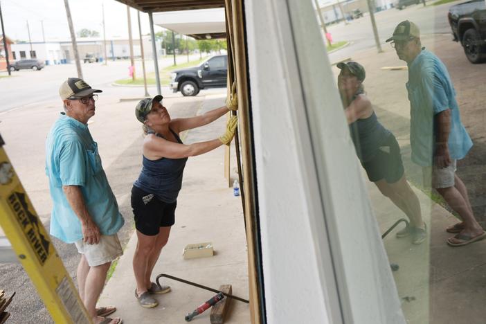 Sherry Cothron and Jimmy May board windows as they prepare for Hurricane Beryl's arrival, Sunday, July 7, 2024, in Port Lavaca, Texas.
