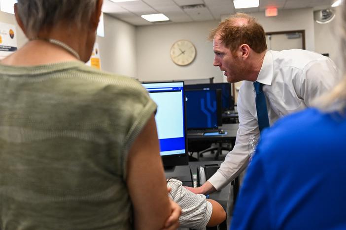 Maricopa County Recorder Stephen Richer demonstrates signature verification for early voting ballots to a tour group of Republican women on June 3 in Phoenix. Richer himself faces primary challengers this month.