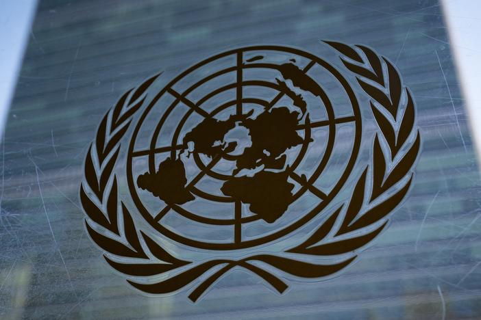 The symbol of the United Nations is displayed outside the Secretariat Building, Feb. 28, 2022, at United Nations Headquarters. 