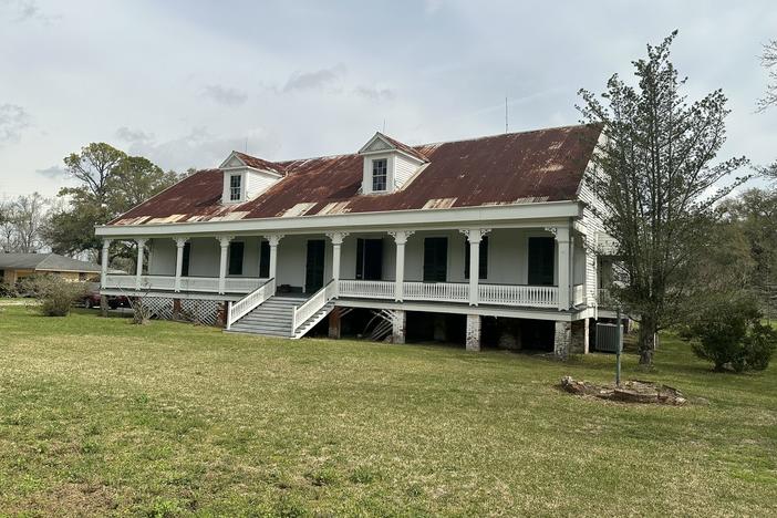The Woodland Plantation House sits near the banks of the Mississippi River in LaPlace, La. The raised creole-style building with a rusty tin roof and wide front porch has Black owners for the first time. The site is historically significant because it's where one of the largest slave revolts in U.S. history began.
