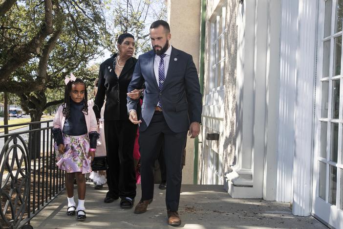Tessie Prevost, center, and 7-year-old Elan Jolie Hebert are escorted by U.S. Marshal Michael Atkins up the steps of McDonogh 19 Elementary School as Prevost was escorted in 1960, during a New Orleans 61st anniversary ceremony in 2021. Prevost was one of the first African-American women who integrated the all-white public schools in New Orleans.