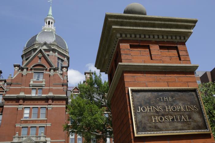 A sign stands in front of part of the Johns Hopkins Hospital complex in Baltimore.