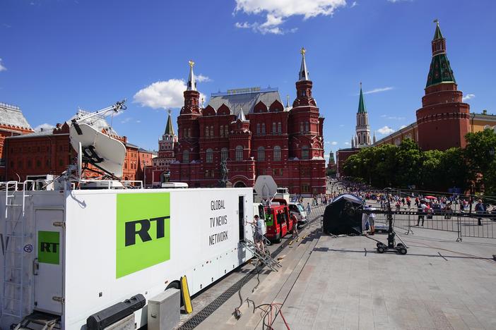 Russian state broadcaster RT broadcasting from near Red Square during the 2018 World Cup in Moscow. The Justice Department alleges an RT employee was behind an AI-powered effort to create fake social media profiles of Americans to spread Russian propaganda in the U.S. 