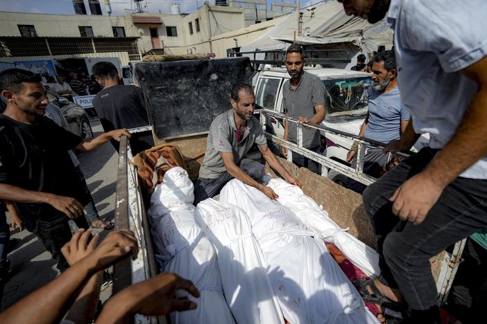 Palestinians gather near the bodies of their relatives killed in the Israeli bombardment of the Gaza Strip, at a hospital morgue in Deir al-Balah, on Saturday.