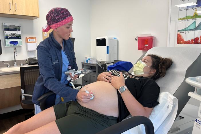 Obstetrician-gynecologist Taylar Swartz uses an ultrasound scanner to check the health of Addie Comegys' baby on May 30. Comegys, who is due in late August, had traveled 45 minutes for her prenatal appointment at Mahaska Health in Oskaloosa, one of a few rural hospitals in Iowa still offering labor and delivery services.