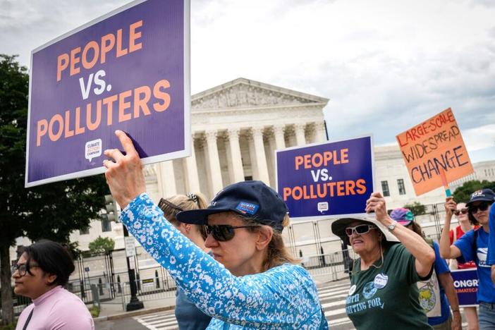 Environmental activists rally in front of the U.S. Supreme Court in 2022 after it ruled against the Obama administration's plan to cut climate-warming emissions at the nation's power plants. The Supreme Court has since further limited the power of federal agencies like the Environmental Protection Agency.