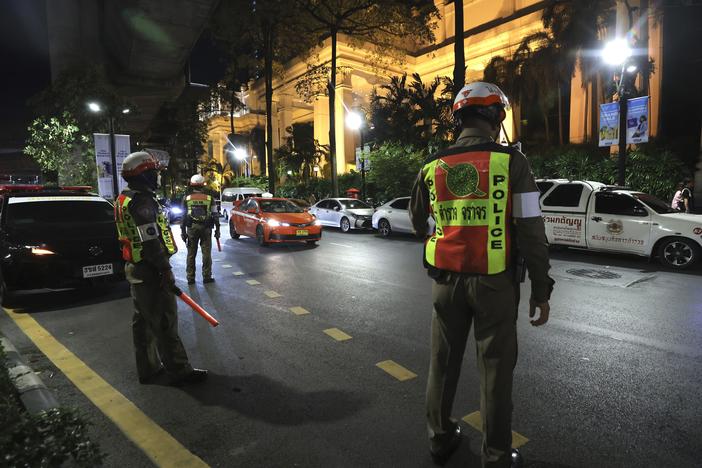Police officers stand outside the Grand Hyatt Erawan Hotel in Bangkok, Thailand, on Tuesday. Police said a number of people were found dead Tuesday in the luxury hotel in downtown Bangkok and poisoning is suspected.