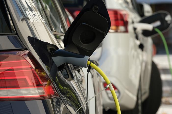  An electric car and a plug-in hybrid car charge at a public charging station on October 12, 2019 in Berlin, Germany.