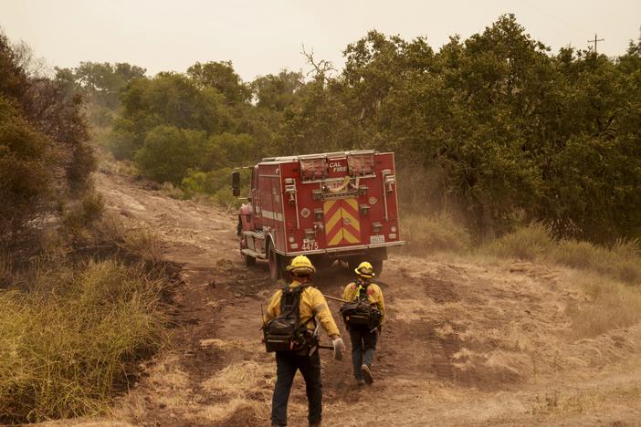 Firefighters work against the advancing Lake Fire in Los Olivos, Calif., on Saturday, July 6, 2024.