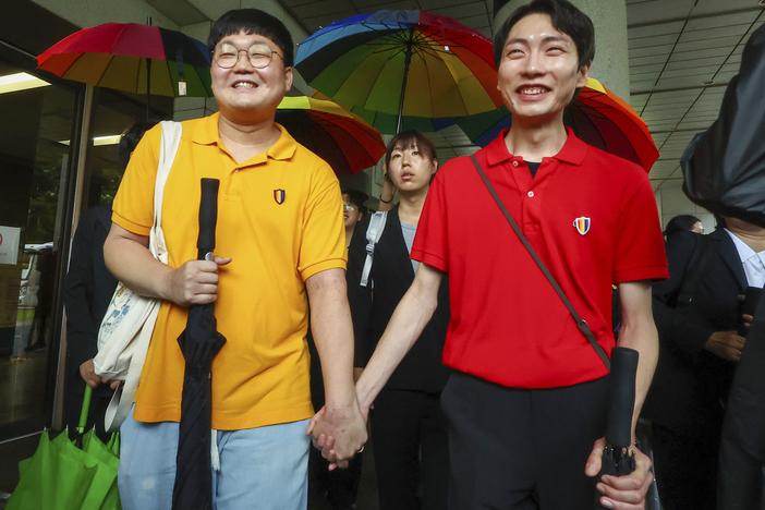 So Seong-wook (left) and Kim Yong Min leave the Supreme Court building in Seoul, South Korea, on Thursday.