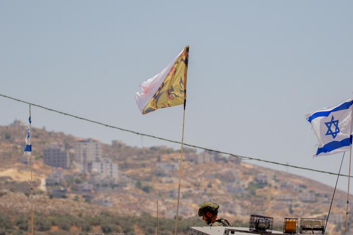 Israeli soldiers and armored vehicles near the West Bank town of Beita 